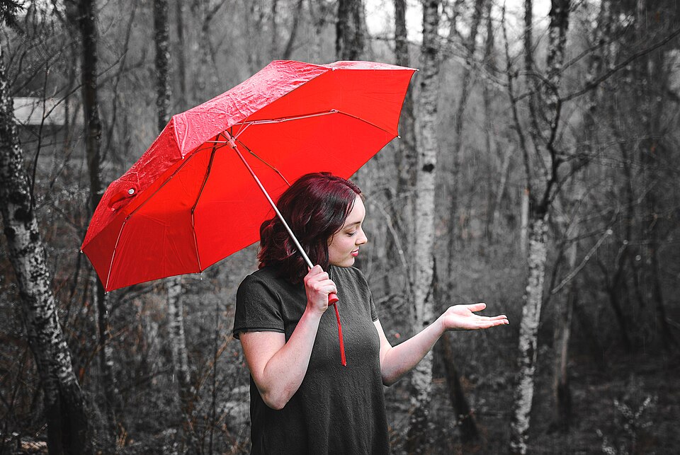Libby holding a red umbrella